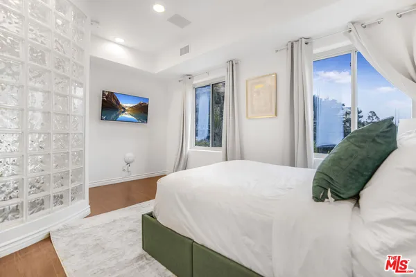 a bedroom with a bed and a couch