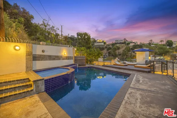 a view of a balcony with two chairs and a table