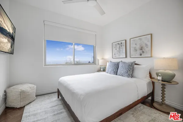 a bedroom with a bed and a painting on the wall