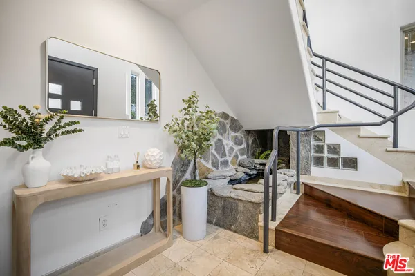 a living room with furniture and flowers