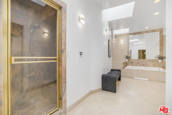 a bathroom with a double vanity sink a toilet a mirror and shower