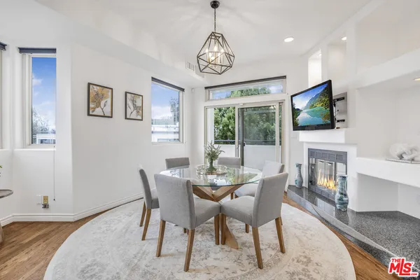 a dining room with furniture window and wooden floor