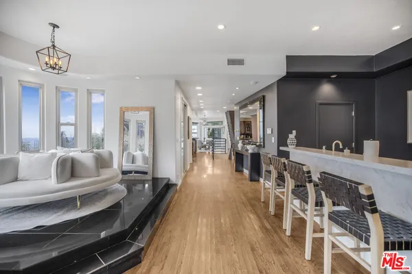 a living room with furniture and a chandelier