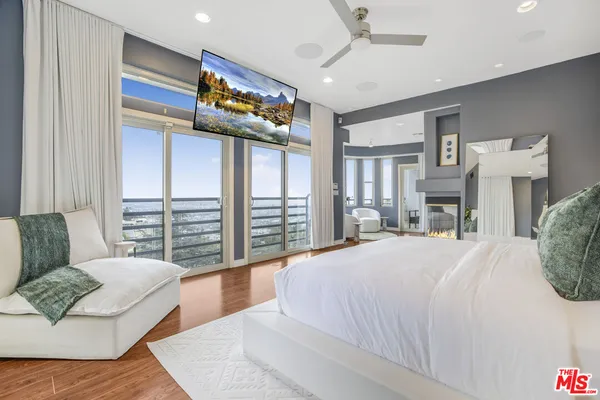 a spacious bedroom with a large bed and a couch