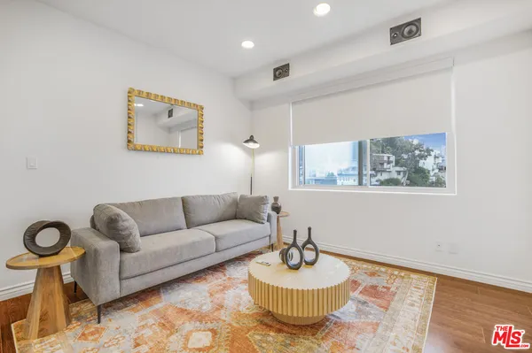 a living room with furniture and a wall