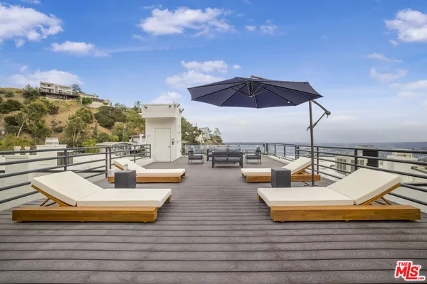 a view of a swimming pool with couches chairs