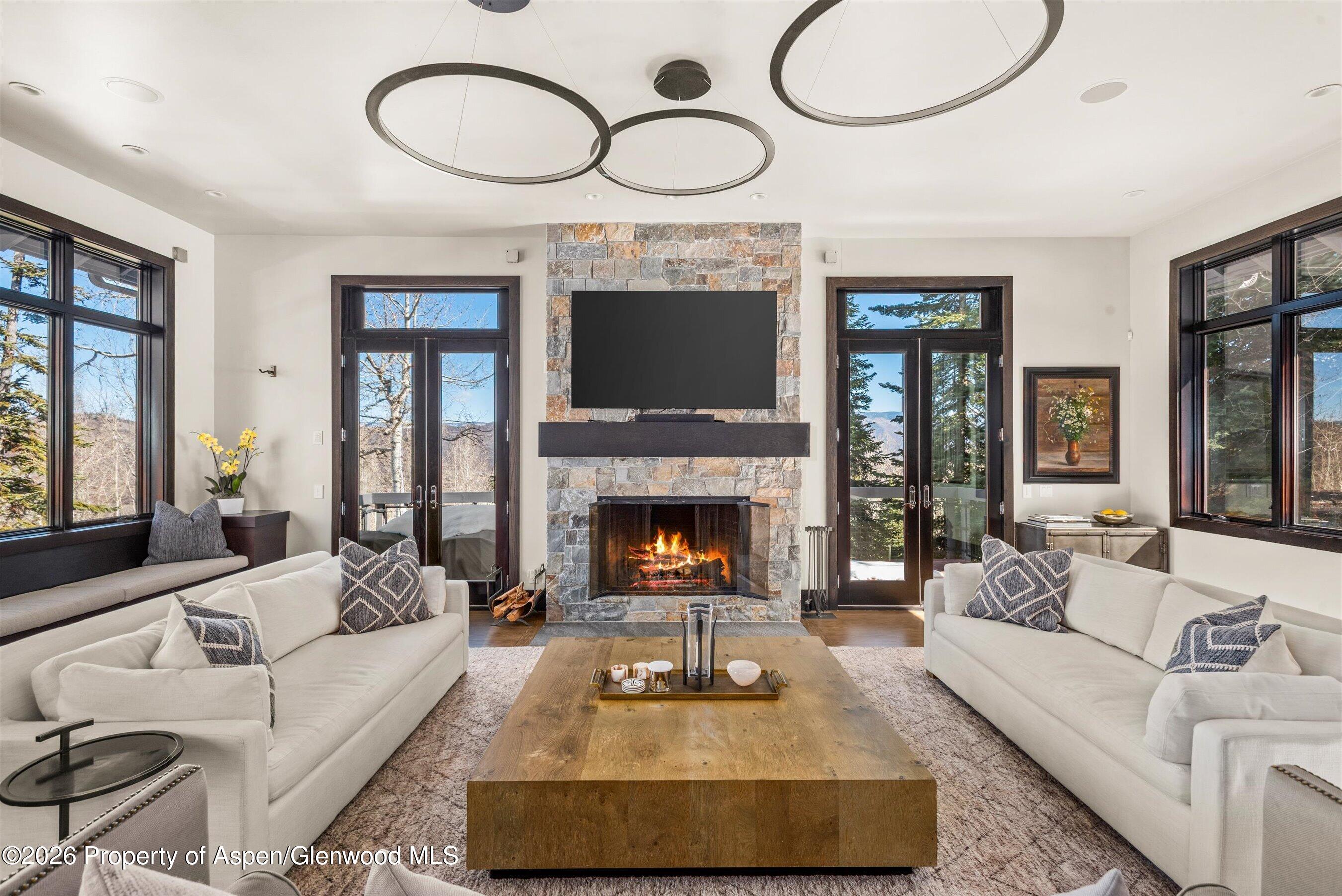 32 Elk Ridge Lane Snowmass Village, CO 81615 - Photo 15 of 58 a living room with furniture a fireplace and a large window