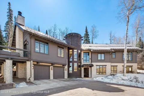 a view of a house with snow on the background