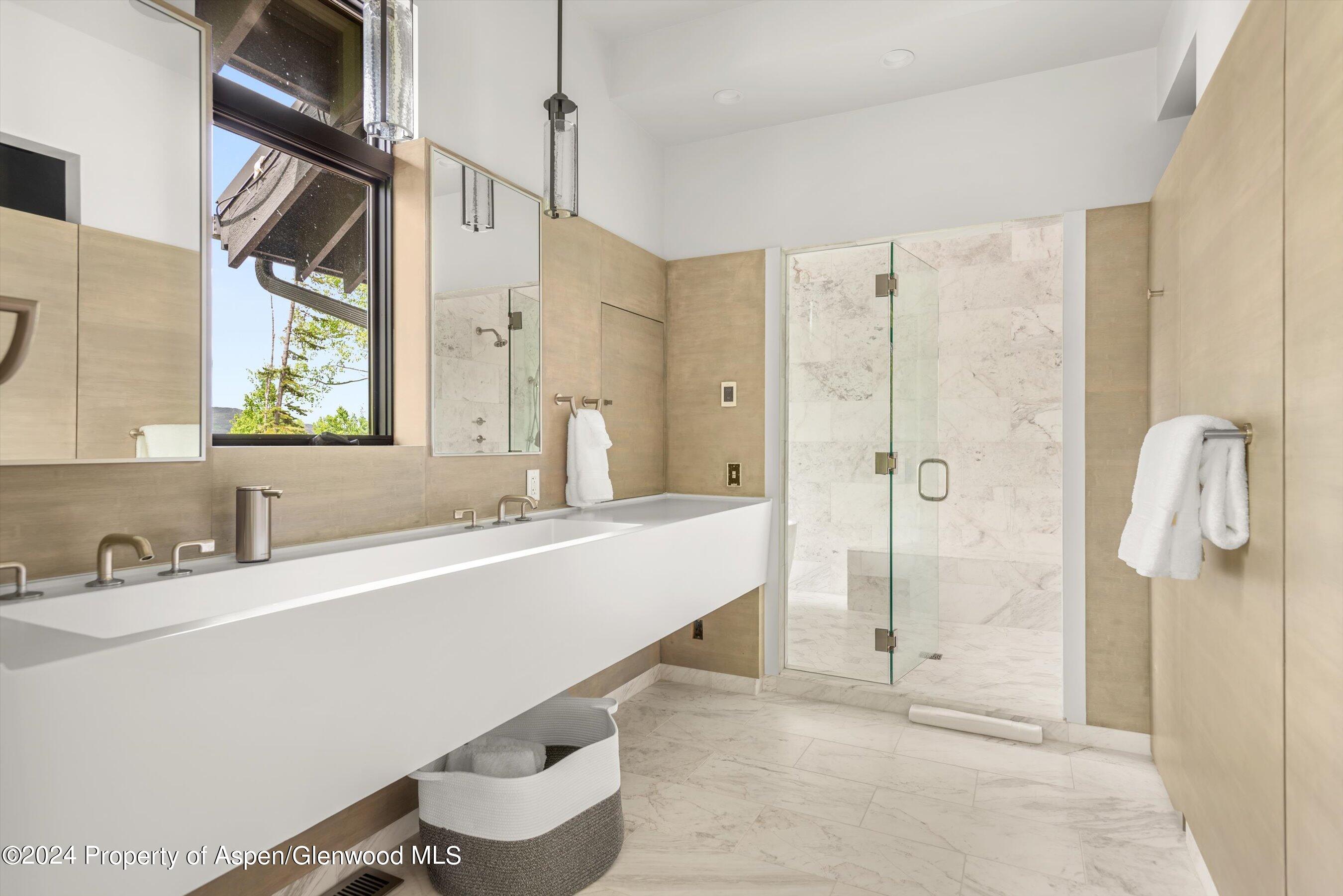 32 Elk Ridge Lane Snowmass Village, CO 81615 - Photo 27 of 58 a bathroom with a sink and mirror with toilet