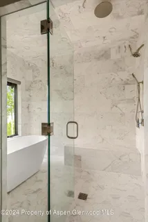 a bathroom with a sink double vanity and a shower