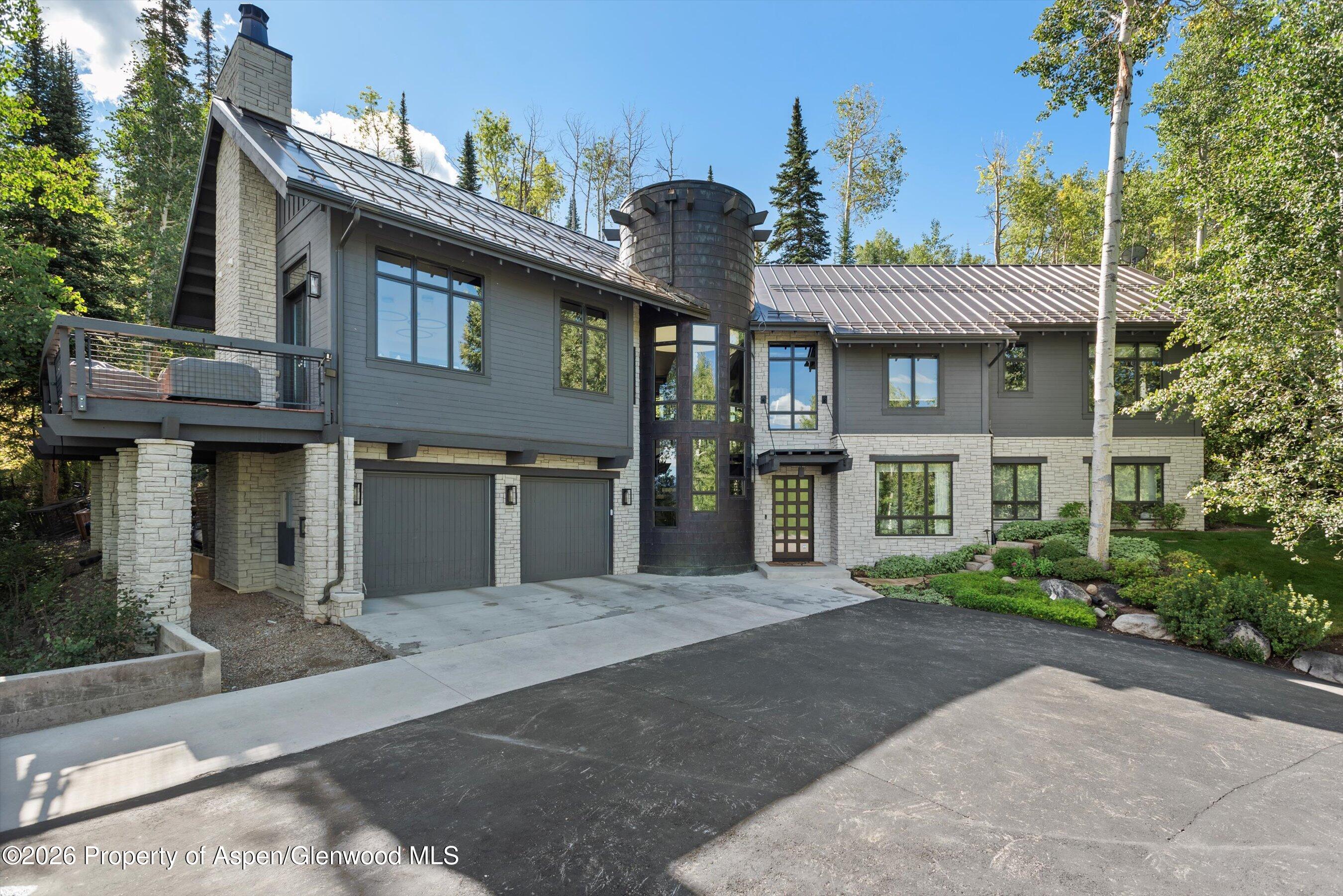 32 Elk Ridge Lane Snowmass Village, CO 81615 - Photo 5 of 58 a front view of a house with garden
