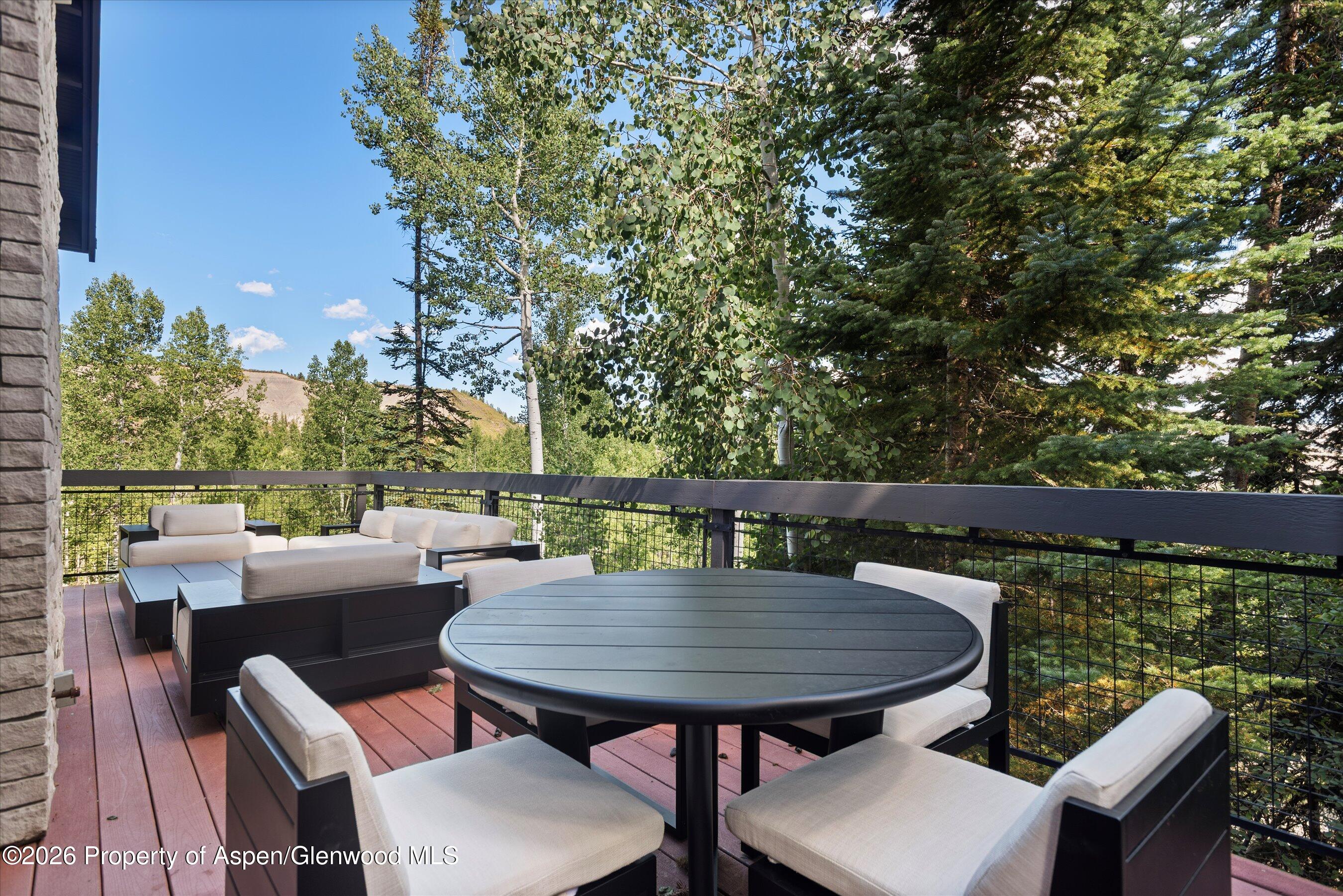 32 Elk Ridge Lane Snowmass Village, CO 81615 - Photo 55 of 58 a balcony with a table and chairs