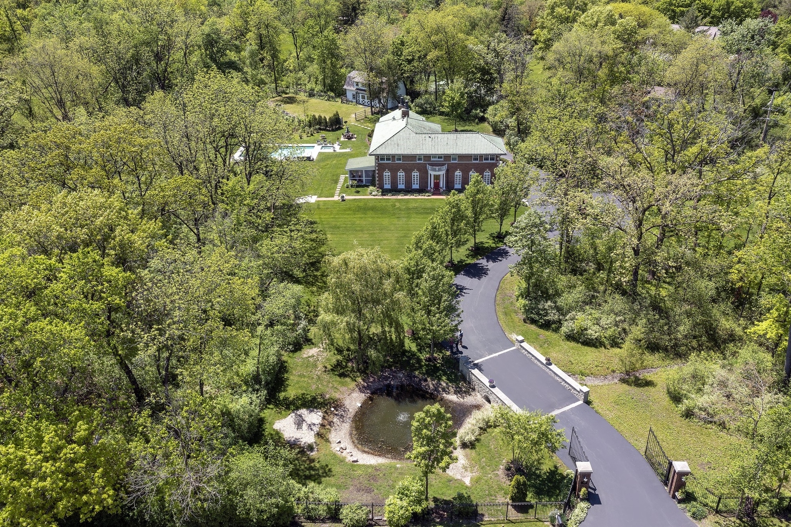 1900 Telegraph Road Bannockburn, IL 60015 - Photo 2 of 47 an aerial view of a house with a yard lake and trees all around