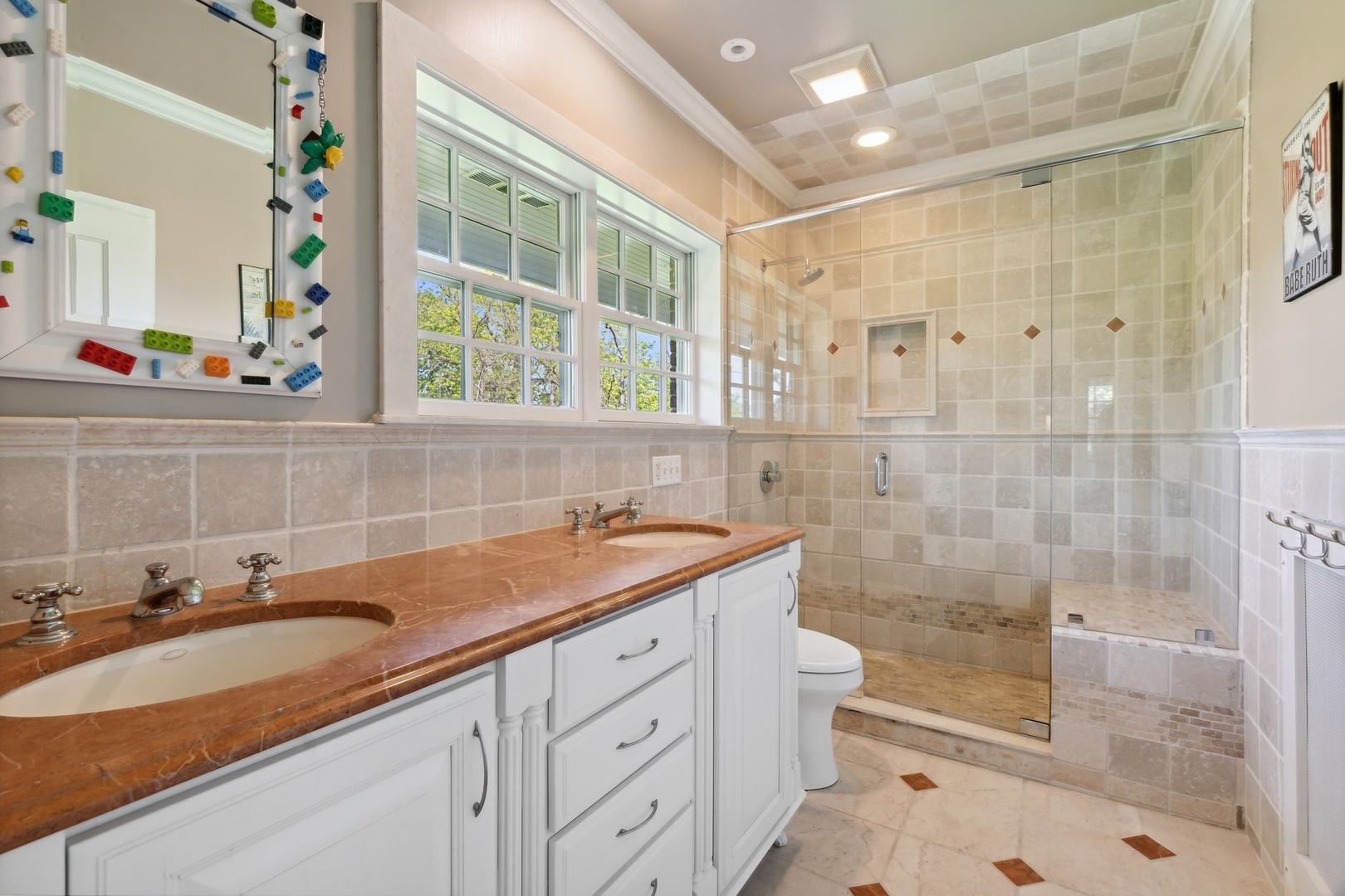 1900 Telegraph Road Bannockburn, IL 60015 - Photo 25 of 47 a bathroom with a shower sink and mirror