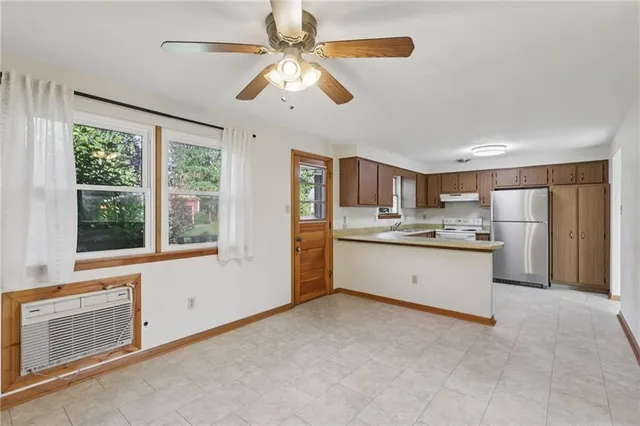 a view of a kitchen with refrigerator and microwave