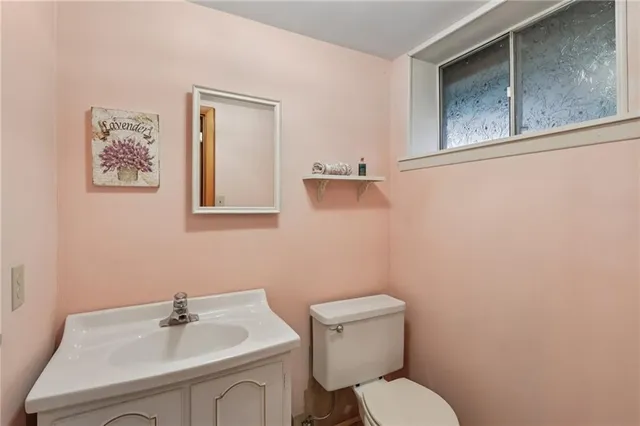 a bathroom with a sink mirror and toilet