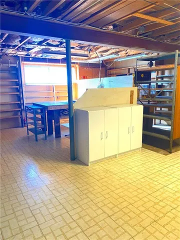 a view of a room with wooden floor