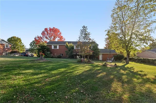a view of house with outdoor space and garden