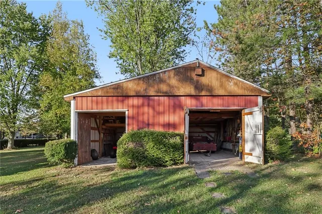 a view of a tiny house with yard and plants
