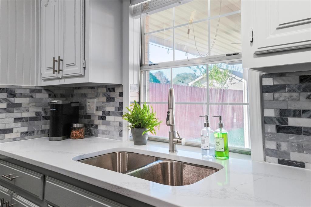1801 Homestead Place Garland, TX 75044 - Photo 1 of 37 a kitchen with a sink and a window