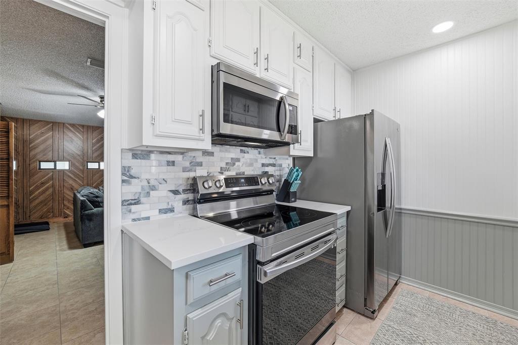 1801 Homestead Place Garland, TX 75044 - Photo 17 of 37 a kitchen with a refrigerator stove and microwave
