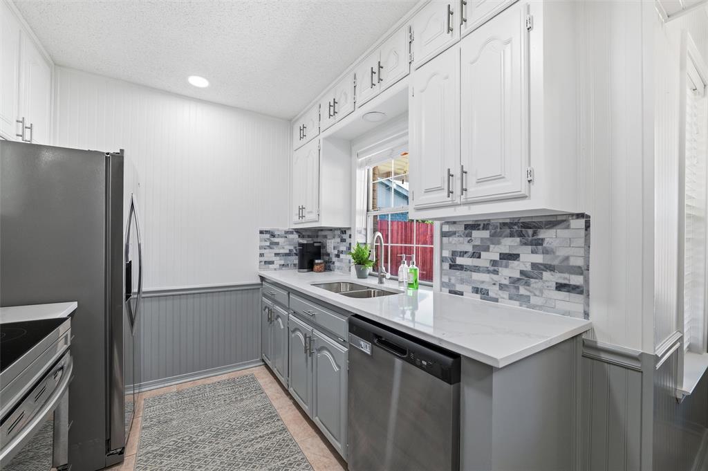 1801 Homestead Place Garland, TX 75044 - Photo 2 of 37 a kitchen with stainless steel appliances a refrigerator and cabinets
