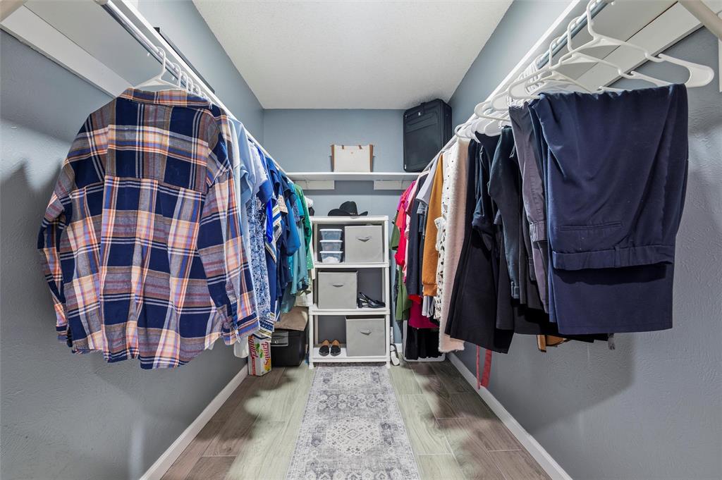 1801 Homestead Place Garland, TX 75044 - Photo 21 of 37 a view of walk in closet with clothes and shoes