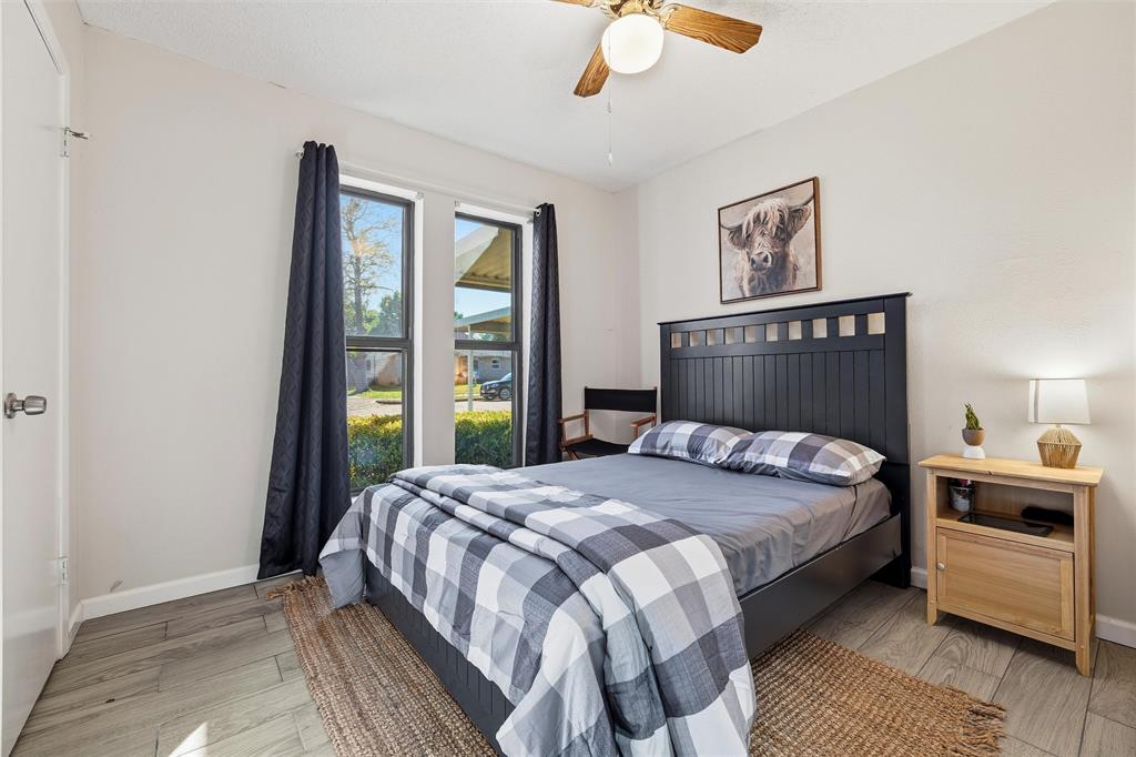 1801 Homestead Place Garland, TX 75044 - Photo 23 of 37 a bedroom with a bed a chandelier and a window