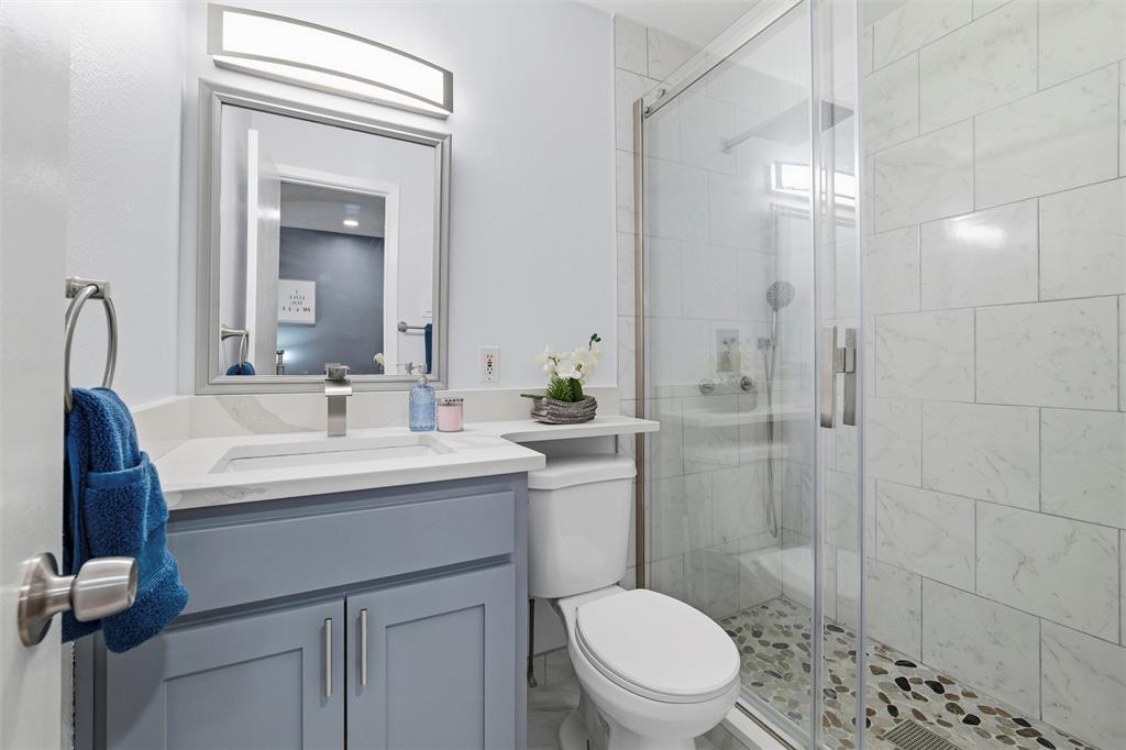 1801 Homestead Place Garland, TX 75044 - Photo 26 of 37 a bathroom with a sink a toilet and shower