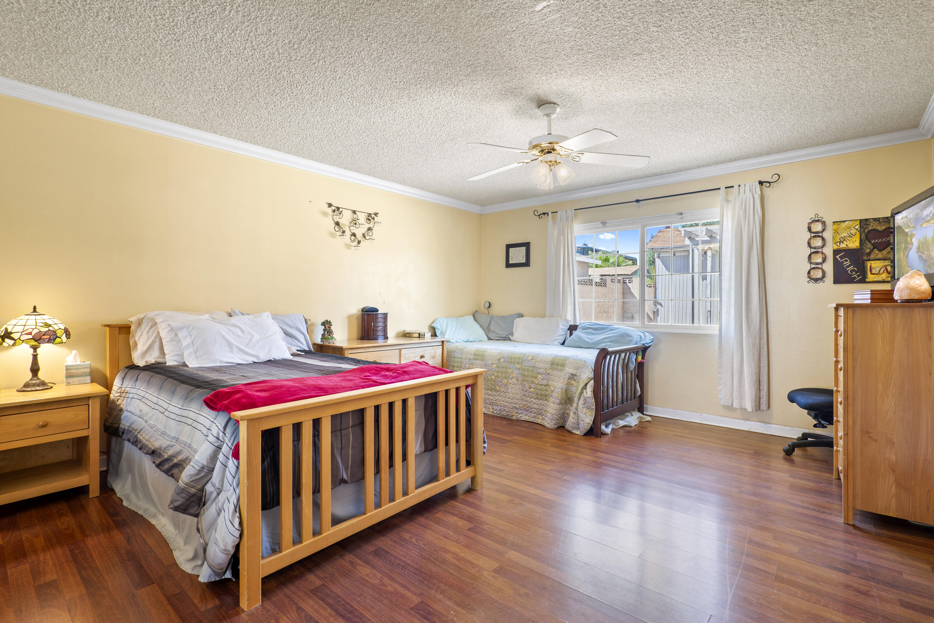 41235 47th Street West Lancaster, CA 93536 - Photo 14 of 43 a bedroom with a bed and a chandelier