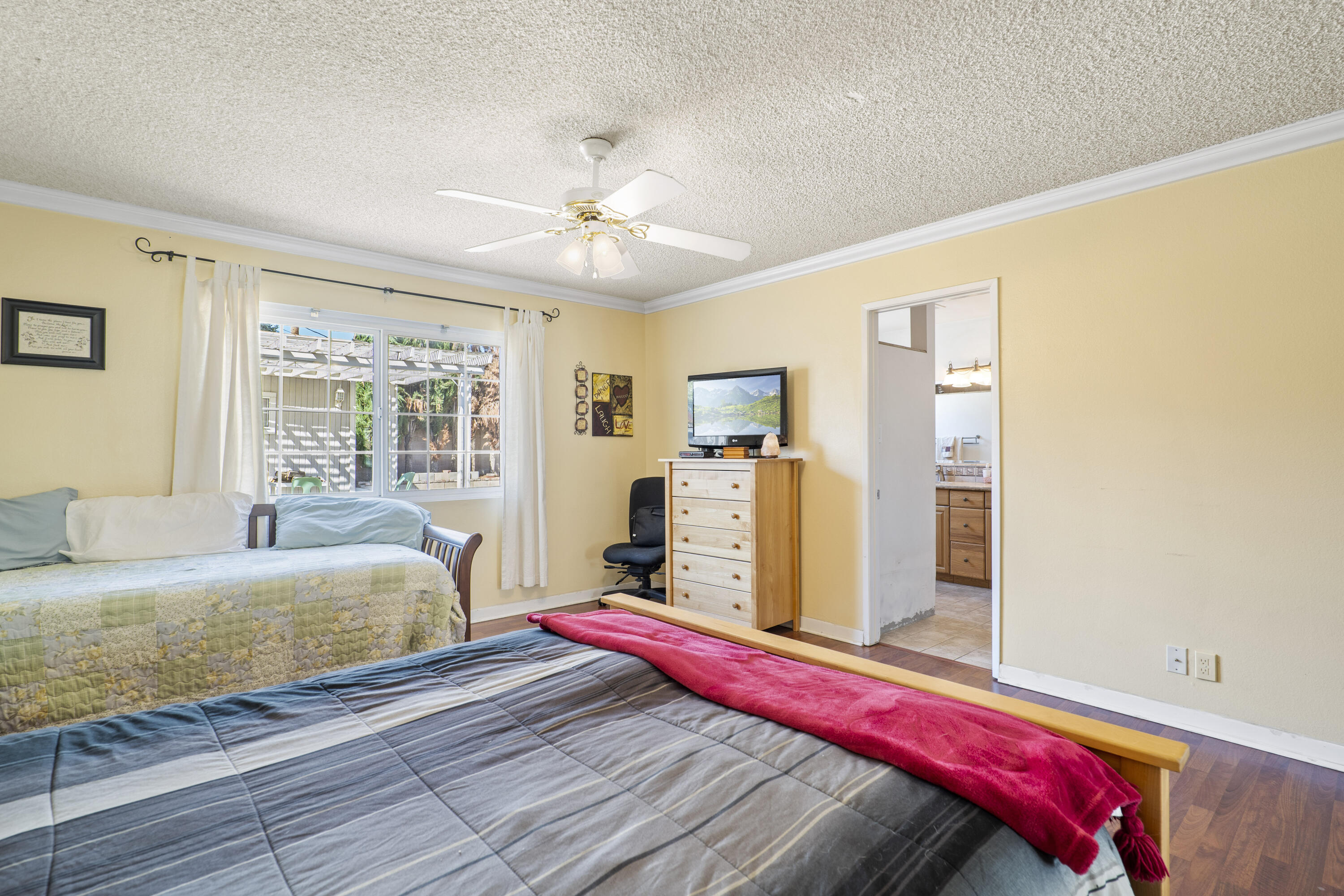 41235 47th Street West Lancaster, CA 93536 - Photo 15 of 43 a bedroom with a bed and a chandelier
