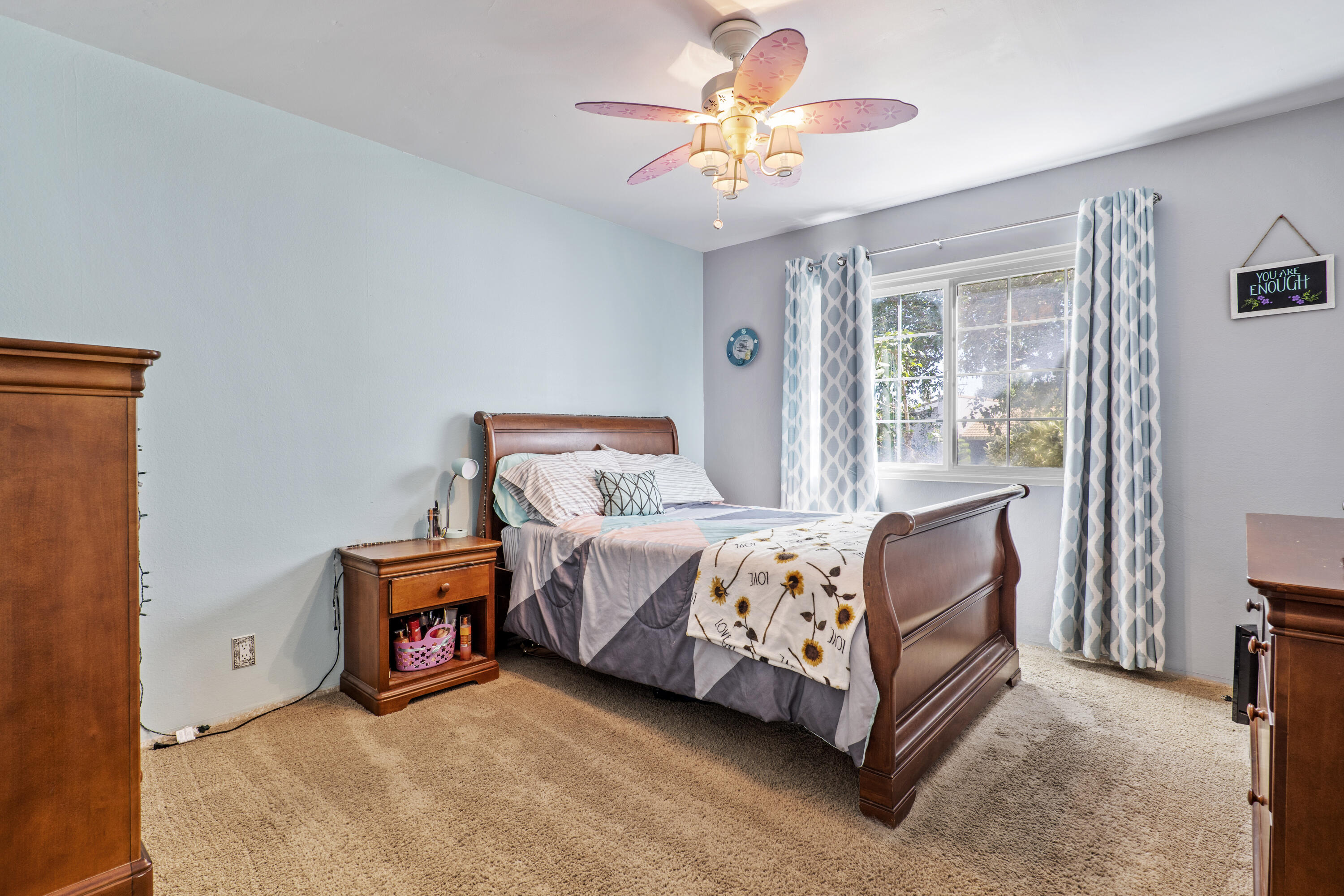 41235 47th Street West Lancaster, CA 93536 - Photo 18 of 43 a bed room with a bed and a chandelier