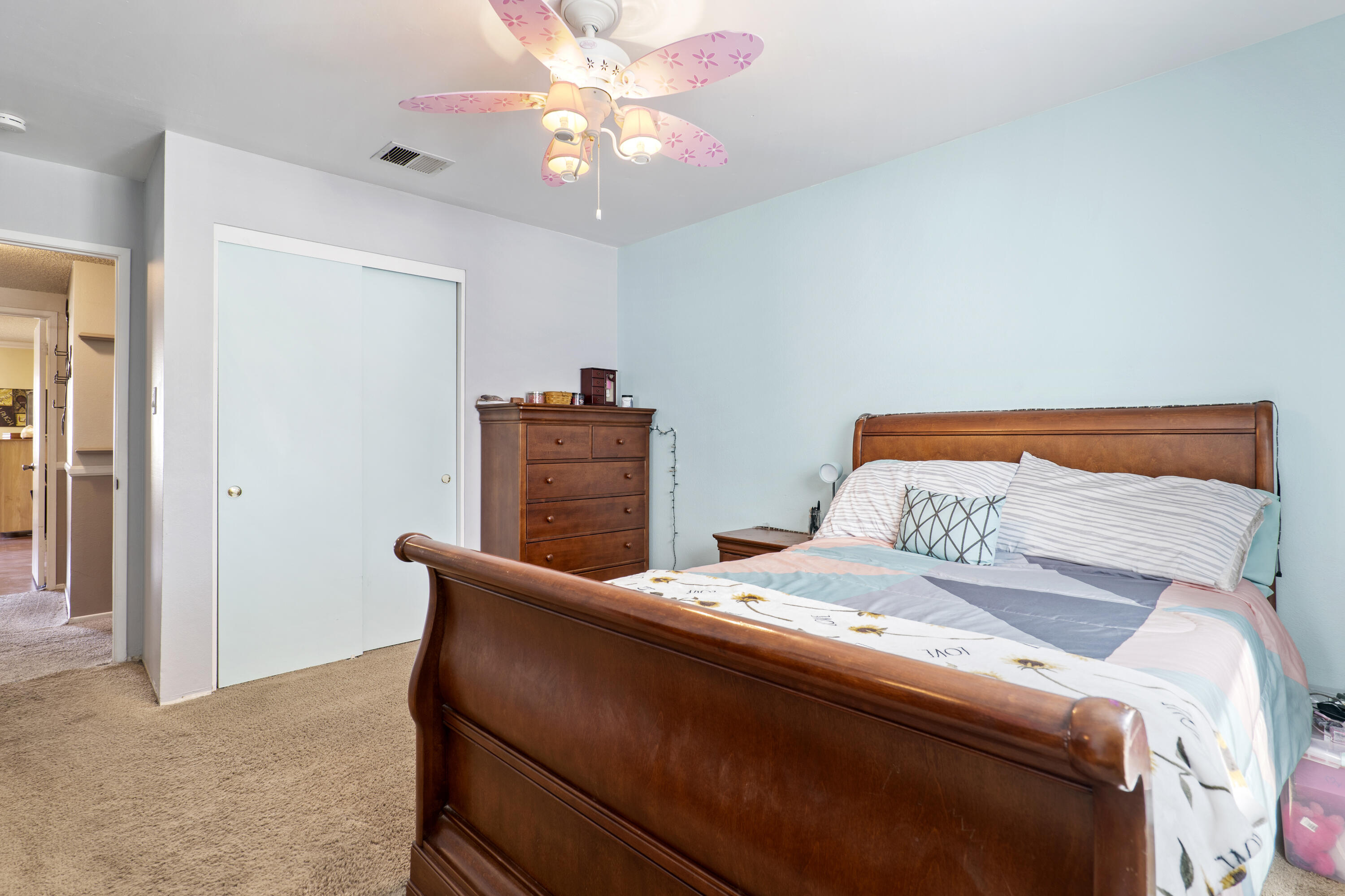 41235 47th Street West Lancaster, CA 93536 - Photo 19 of 43 a bedroom with a bed and a chandelier