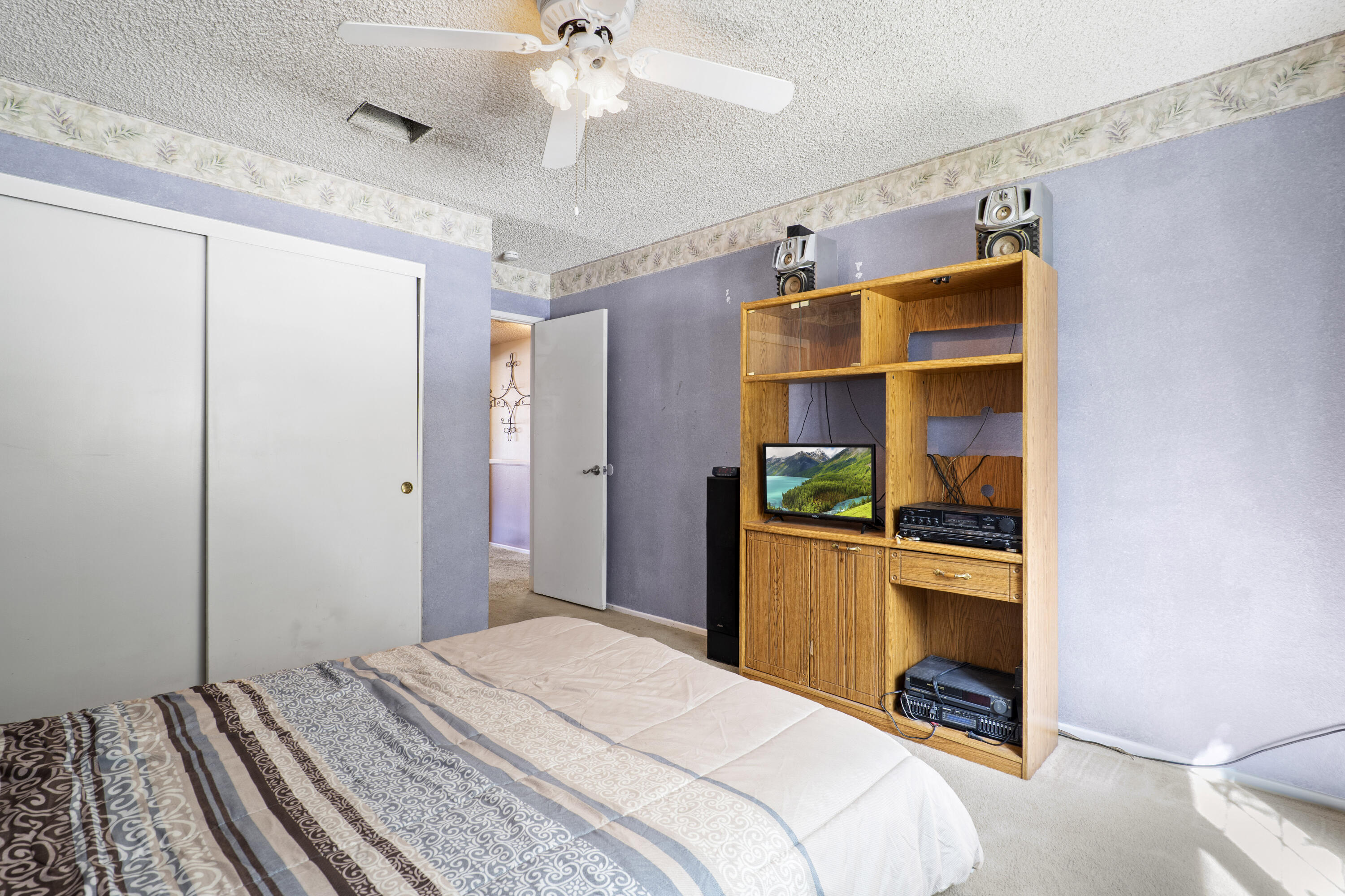 41235 47th Street West Lancaster, CA 93536 - Photo 21 of 43 a bedroom with a bed and a chandelier