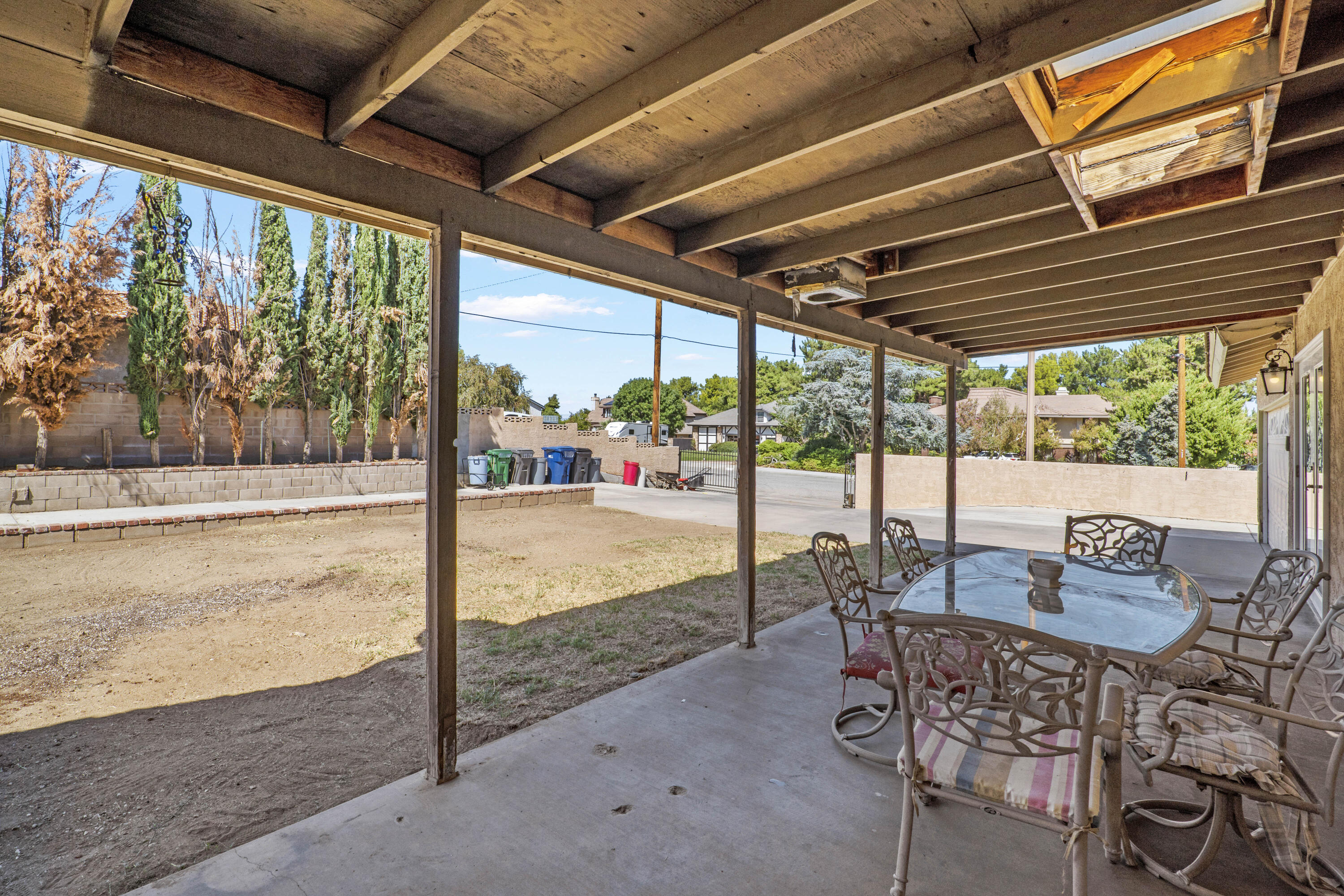41235 47th Street West Lancaster, CA 93536 - Photo 23 of 43 a patio with yard glass top table and chairs