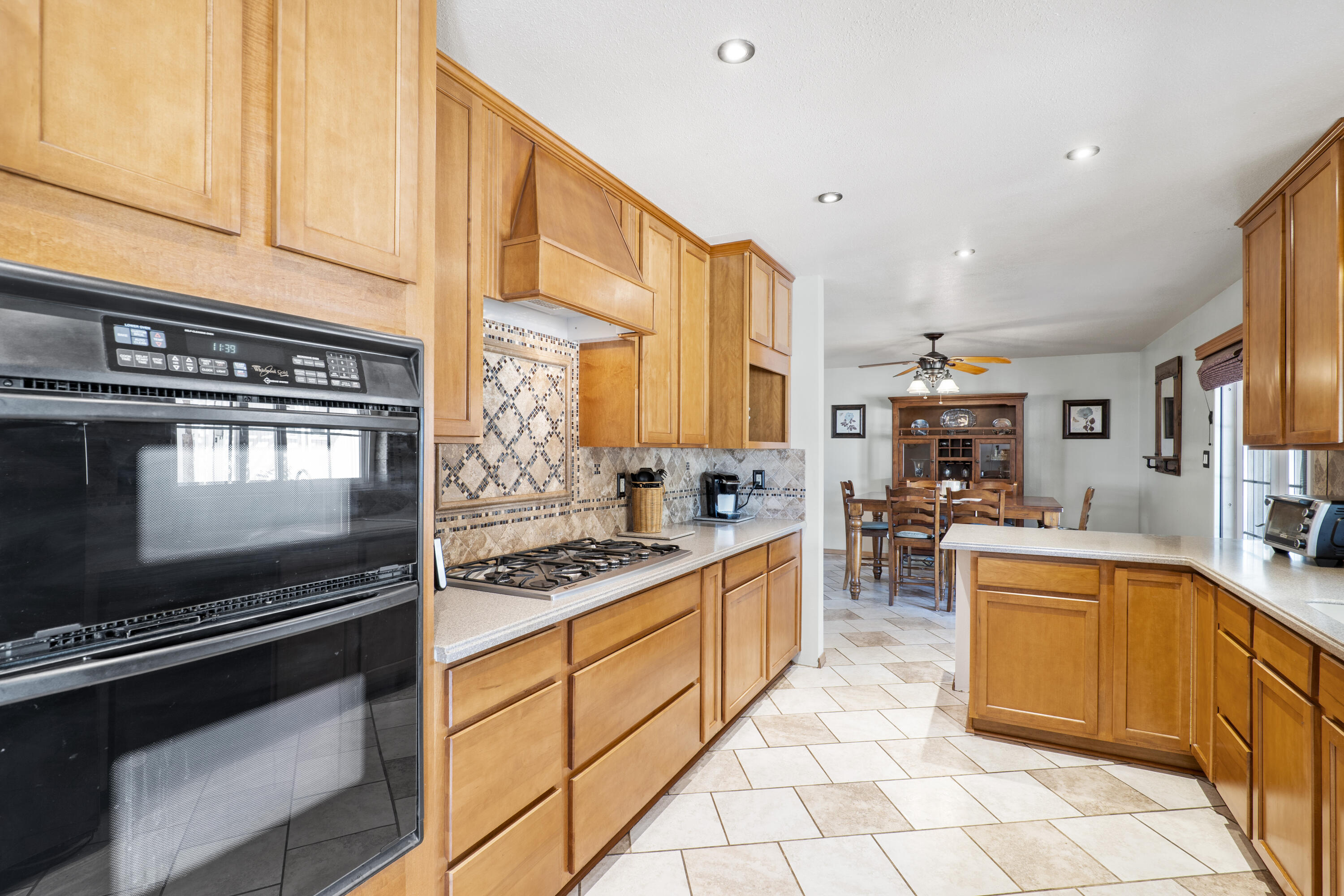 41235 47th Street West Lancaster, CA 93536 - Photo 6 of 43 a kitchen with stainless steel appliances granite countertop a stove top oven a sink dishwasher and cabinets with wooden floor