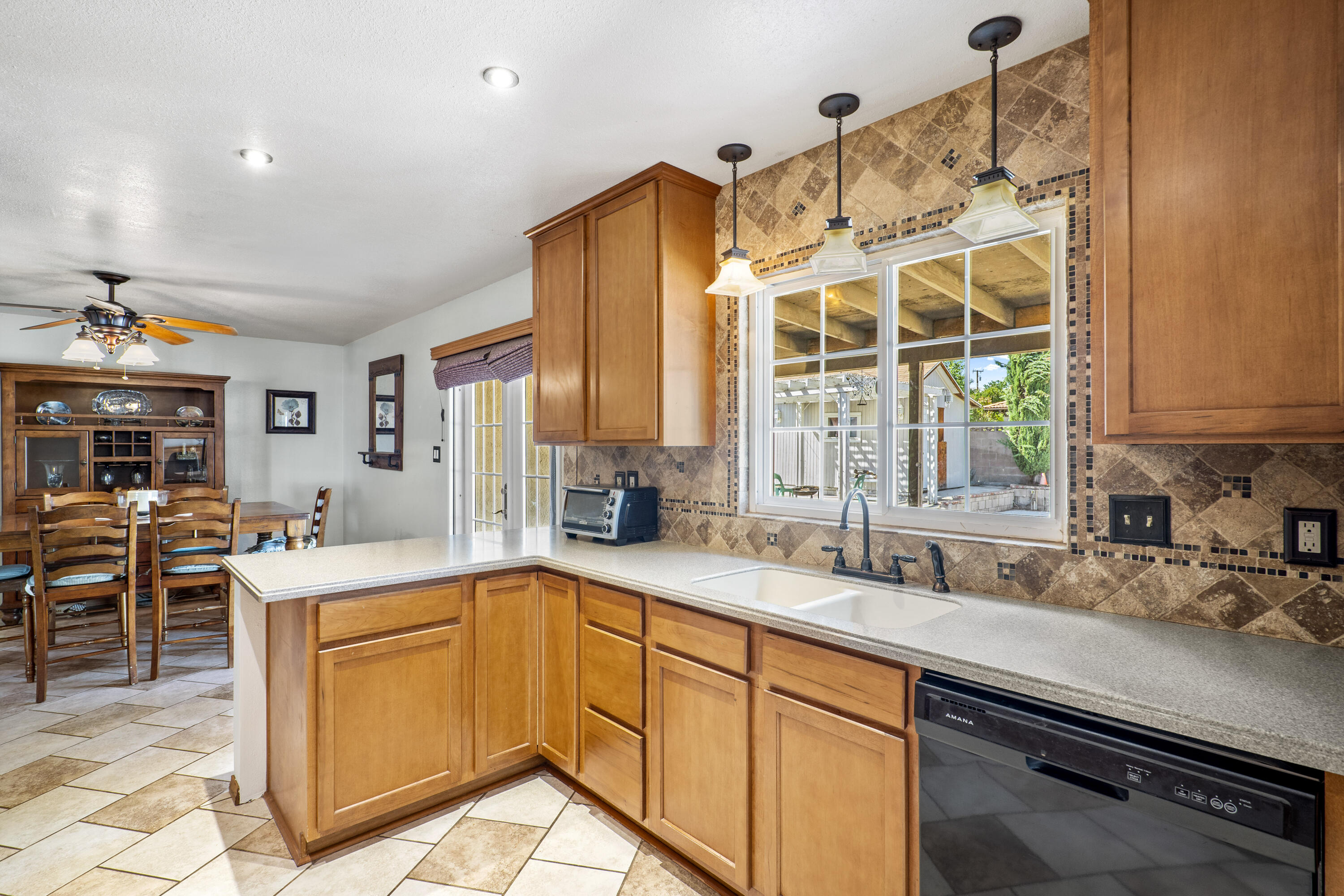 41235 47th Street West Lancaster, CA 93536 - Photo 9 of 43 a kitchen with stainless steel appliances a sink a stove and a refrigerator