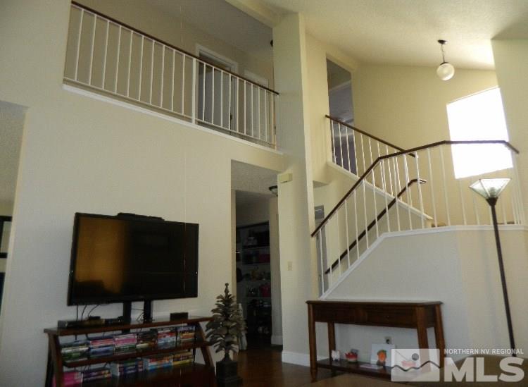 5885 Starcrest Avenue Reno, NV 89523 - Photo 11 of 18 a living room with stairs and a flat screen tv