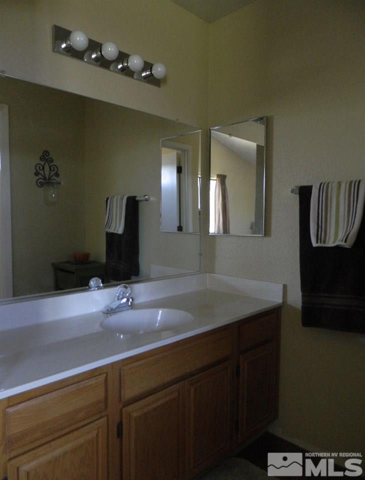 5885 Starcrest Avenue Reno, NV 89523 - Photo 13 of 18 a bathroom with a sink and a mirror