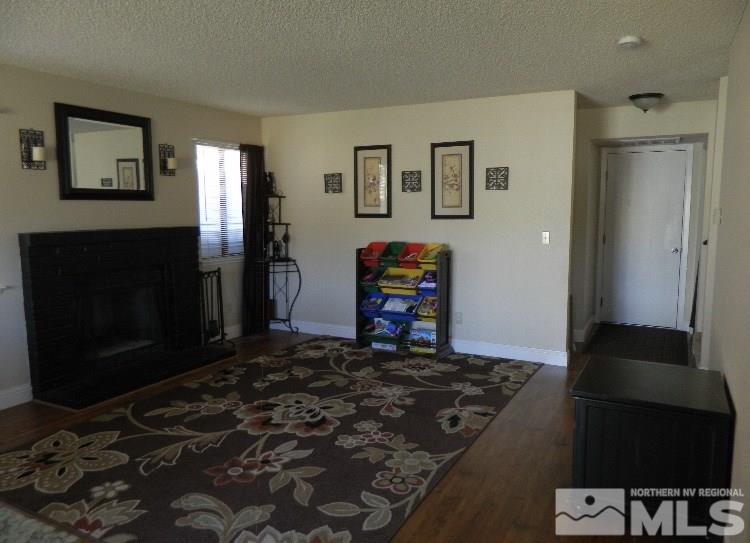 5885 Starcrest Avenue Reno, NV 89523 - Photo 8 of 18 a bedroom with a bed and wooden floor