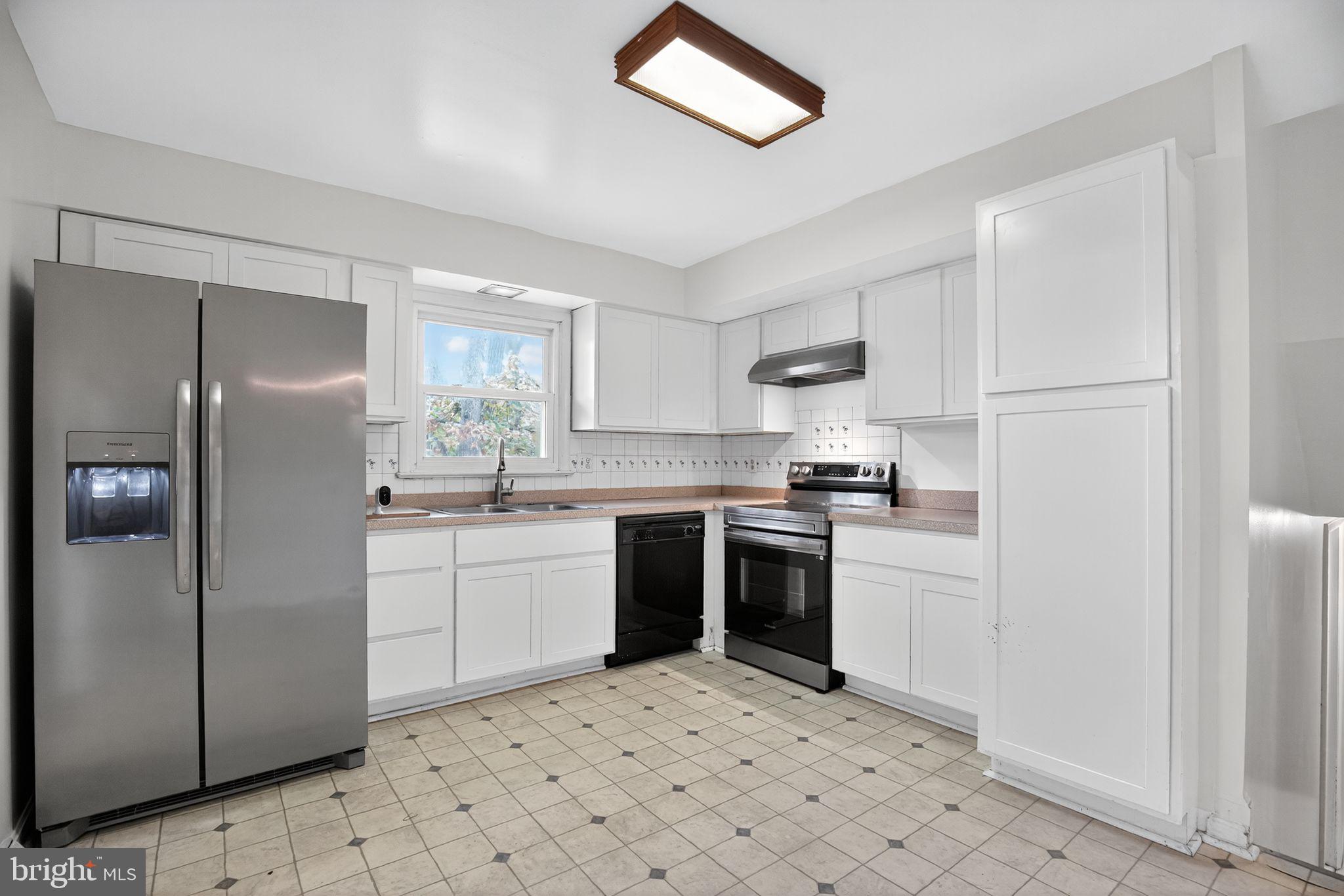 45869 Belvoir Road Great Mills, MD 20634 - Photo 11 of 30 a kitchen with a sink cabinets and stainless steel appliances