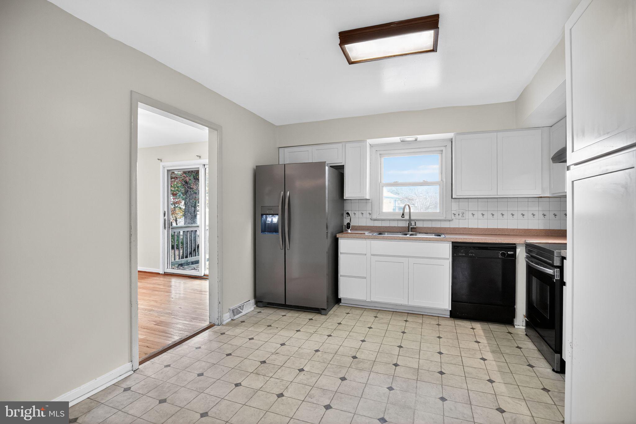 45869 Belvoir Road Great Mills, MD 20634 - Photo 12 of 30 a kitchen with a refrigerator sink and cabinets