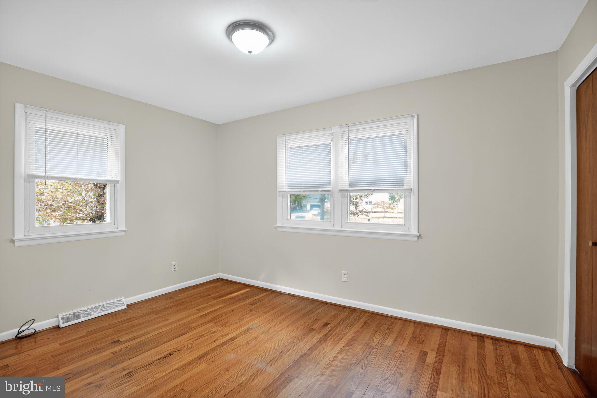 45869 Belvoir Road Great Mills, MD 20634 - Photo 17 of 30 an empty room with wooden floor and windows