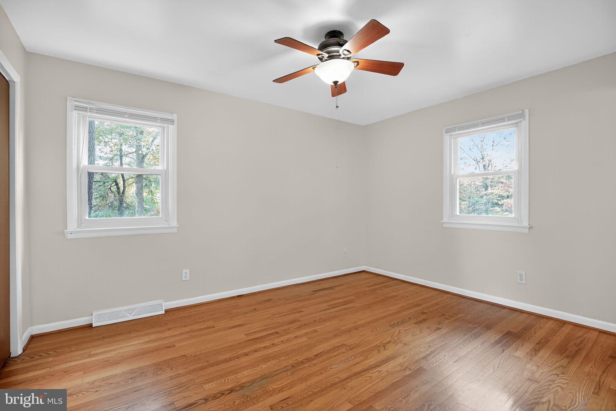 45869 Belvoir Road Great Mills, MD 20634 - Photo 19 of 30 a view of a room with wooden floor and a ceiling fan