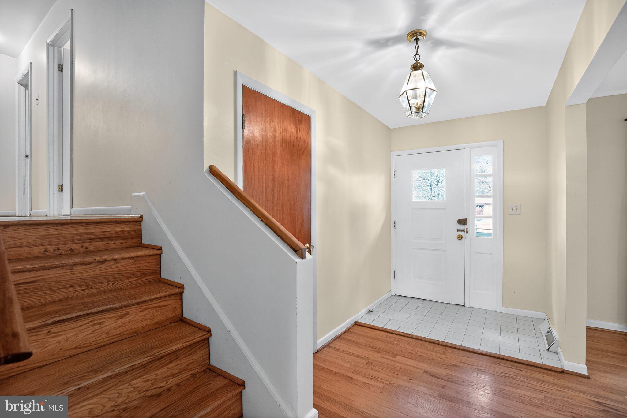 45869 Belvoir Road Great Mills, MD 20634 - Photo 3 of 30 a view of a hallway with wooden floor and staircase