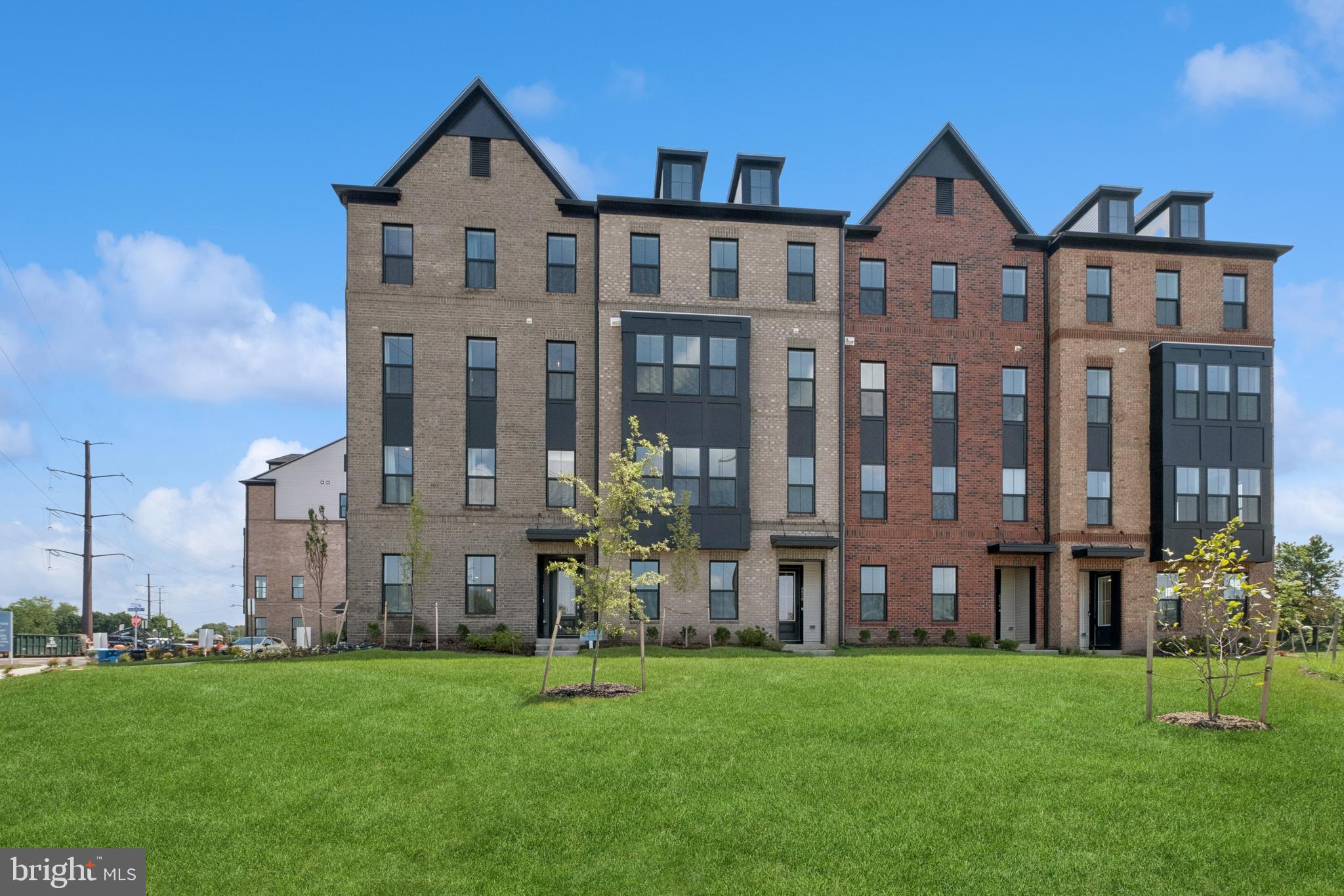 a front view of a residential apartment building with a yard
