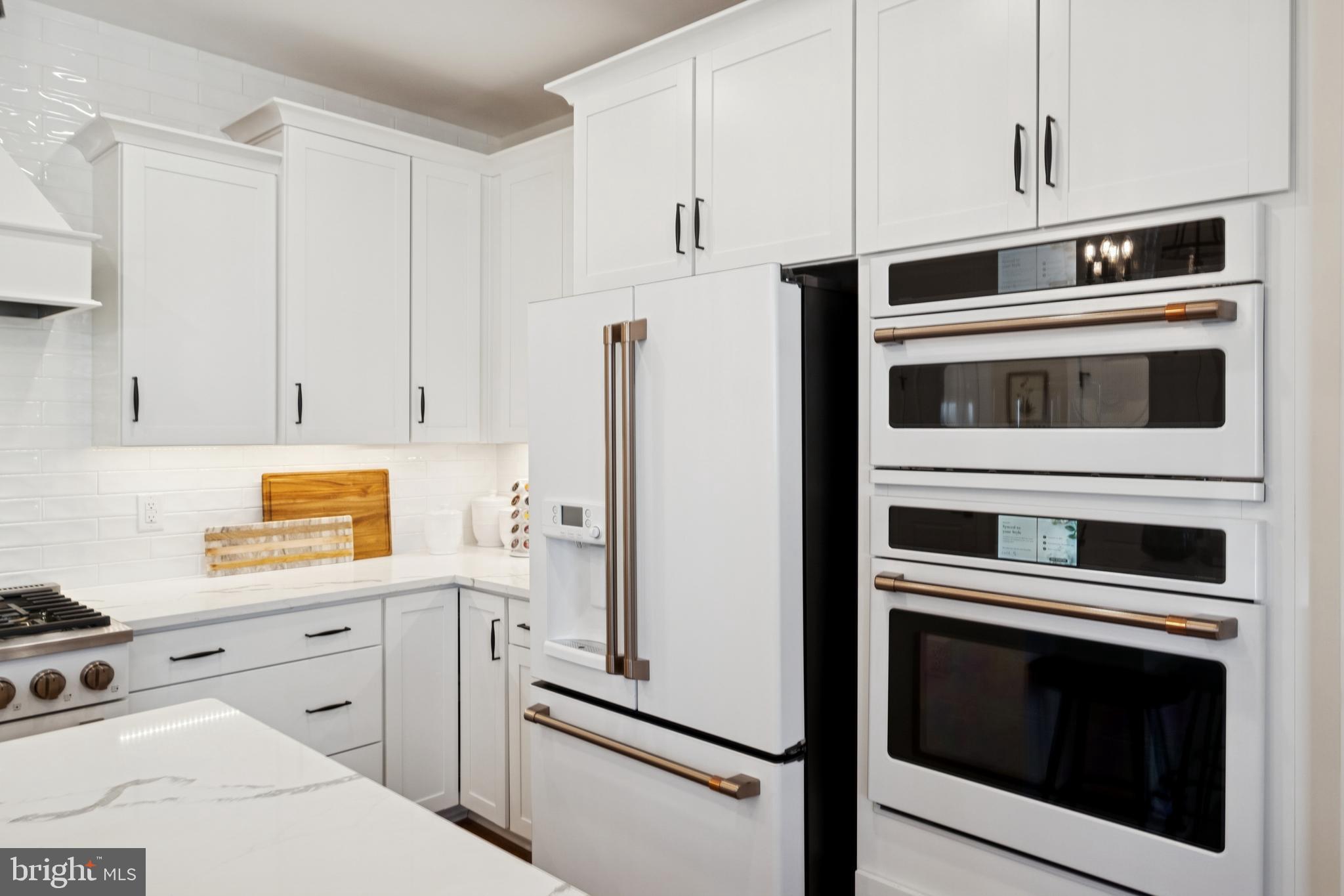 14937 Deco Circle Chantilly, VA 20151 - Photo 11 of 35 a kitchen with stainless steel appliances white cabinets and white appliances