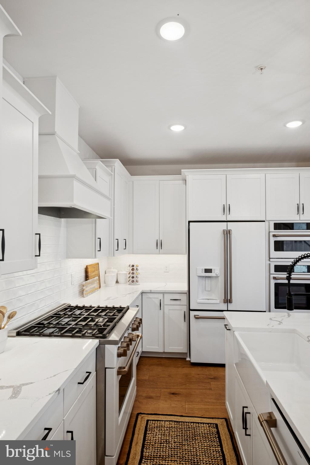 14937 Deco Circle Chantilly, VA 20151 - Photo 17 of 35 a kitchen with kitchen island a stove a sink and a refrigerator