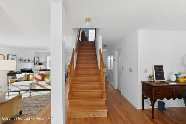 a view of a hallway with workspace and wooden floor