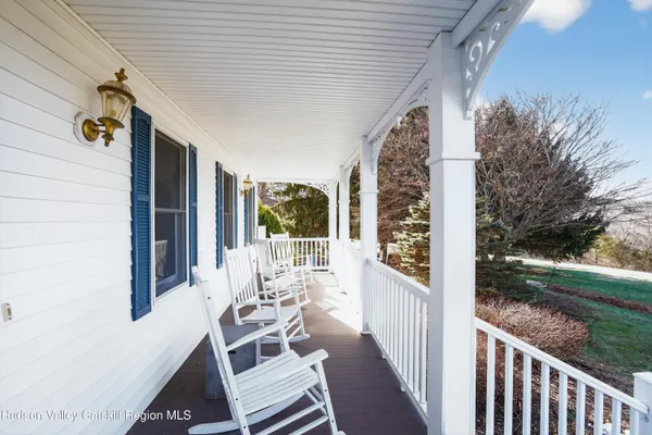 a view of a patio with table and chairs and wooden fence